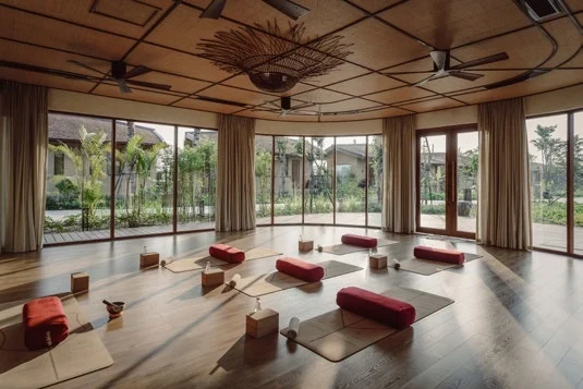 The open-sided yoga pavilion at Namia River Retreat, mats laid out facing the garden